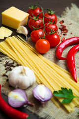 uncooked ingredients for preparing classic Italian food - pasta with sauce