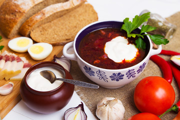 Traditional ukrainian meaty borscht on the table with ingredients