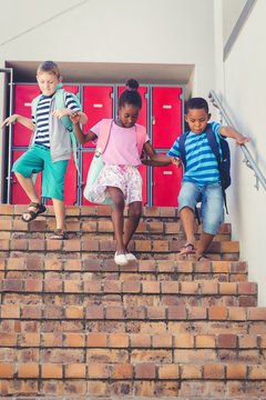 School kids getting down from staircase © WavebreakmediaMicro