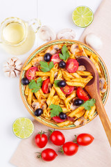 Classic Italian pasta with ingredients on a napkin on a wooden background