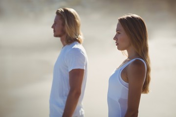 Fototapeta na wymiar Man and woman standing on beach