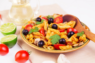 Classic Italian food - pasta with ingredients on a napkin on a wooden background