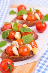 Classic italian bruschetta with tomatoes and garlic on a board