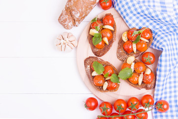 Classic italian bruschetta with tomatoes and garlic on a board