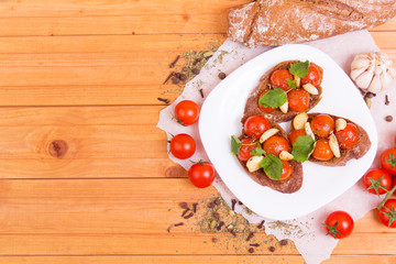 Classic italian bruschetta with tomatoes and garlic on a board