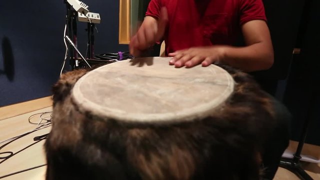 Cool shot of hands playing fur congas during rehearsal