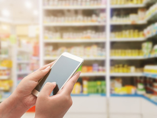 Fototapeta na wymiar Women using smart phone on pharmacy