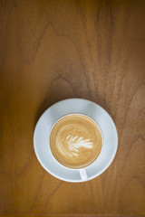 cappuccino cup on wood background