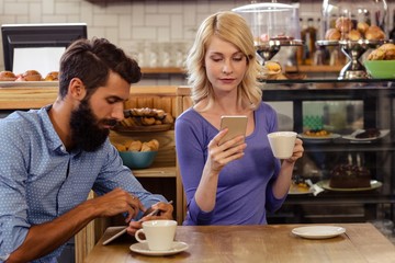 Couple using smartphones