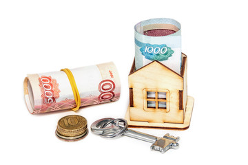 Wooden house, Russian money and key on a white background. Housi