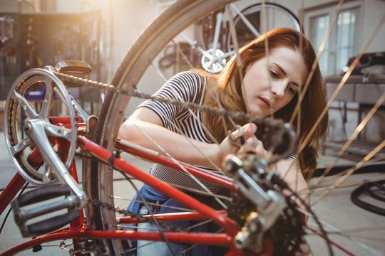 Woman repairing a bicycle