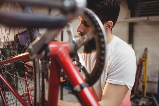 Hipster repairing a bicycle