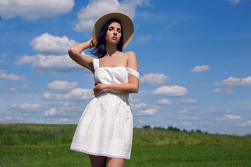 Fototapeta na wymiar young girl in white dress and straw hat