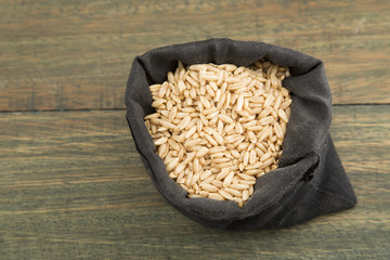 Oat grains on wooden background