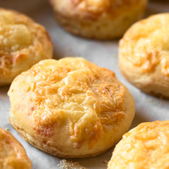 Hungarian traditional Cheese Pogacsa savory baked bread-like pastry, photographed with natural light (Selective Focus, Focus in the middle of the pogacsa)