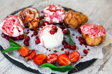 Beautiful multi-colored cakes with fresh fruit arranged on a plate