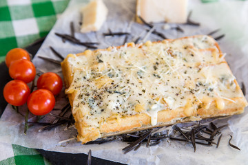 Belgian waffle with sauce, Parmesan cheese, rosemary and cherry tomatoes