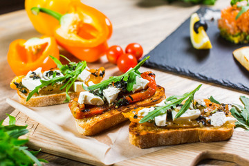 Beautiful fresh sandwiches with cheese, tomatoes and arugula
