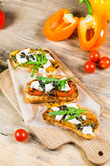Beautiful fresh sandwiches with cheese, tomatoes and arugula