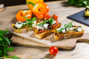 Beautiful fresh sandwiches with cheese, tomatoes and arugula