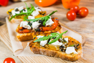 Beautiful fresh sandwiches with cheese, tomatoes and arugula