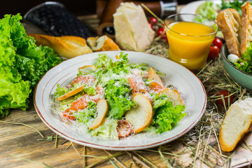 Beautiful fresh salad with lettuce, tomatoes, croutons and Parmesan cheese