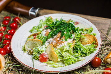Beautiful fresh salad with lettuce, tomatoes, croutons and Parmesan cheese