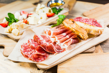 Delicious and tasty meat dishes. Ham, salami, prosciutto. Italian appetizers.