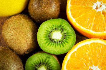 Juicy kiwi fruit and oranges close-up as a natural background
