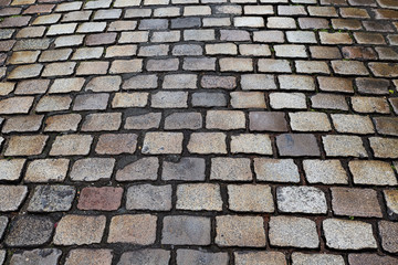 Wet cobblestone street, ideal for backgrounds and textures.