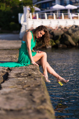 Stylish woman relaxing by the sea at hot summer day