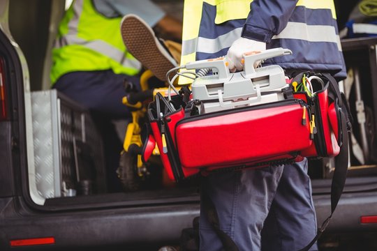 Ambulance man holding a defibrillator