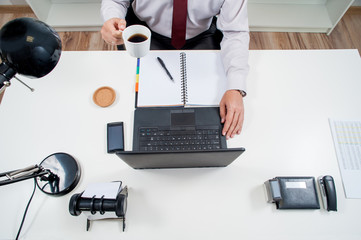 man in office / manager works in office behind the desk