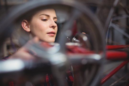 Female mechanic repairing a bicycle