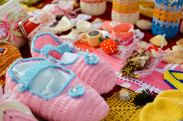Knitted goods displayed on market stall for sale.
