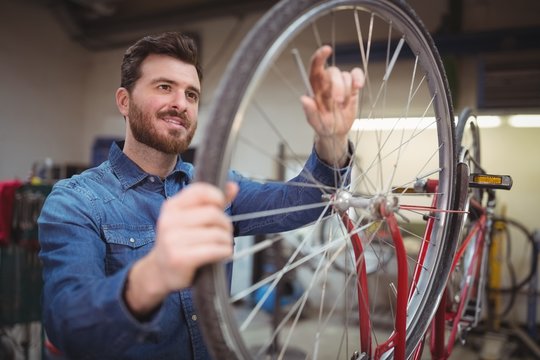 Mechanic repairing a bicycle wheel