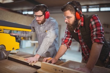 Carpenter using saw cutting machine