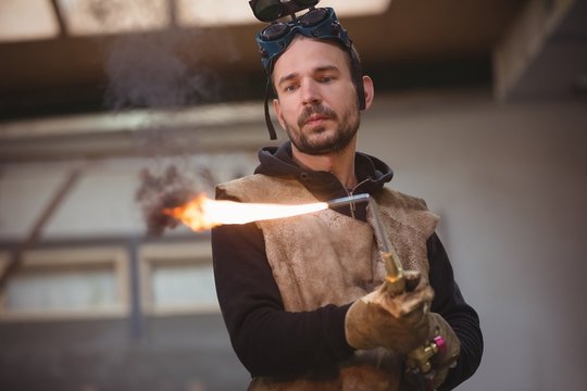 Welder holding a welding torch