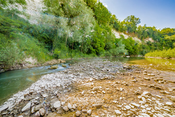 river on the green hills