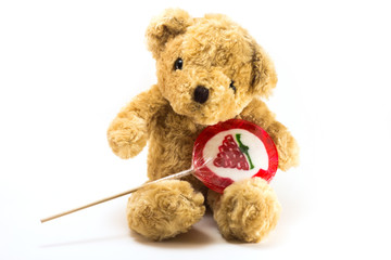 Teddy bear hold red strawberry  Lollipops isolated on white