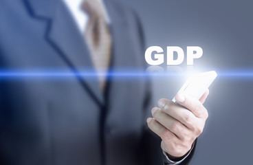 Businessman pressing hand gdp message on virtual screen. Can bring to the medium of your ad.