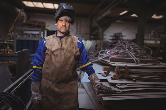 Portrait of welder standing in workshop