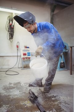 Worker holding a bucket