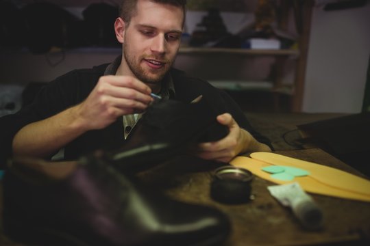 Cobbler painting the shoes
