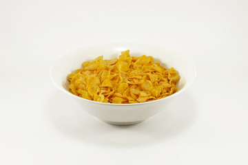 Bowl of cornflakes on colorful table mat