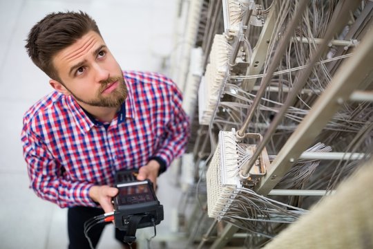 Technician using digital cable analyzer