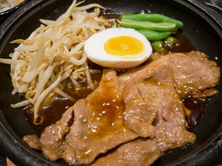 pork with egg and vegetables on hot plate