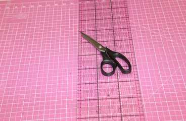 scissors on the worktop with millimeter scale background