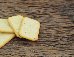 Biscuits with sesame seeds on wood background