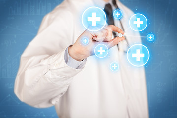 A doctor showing a pill with crosses